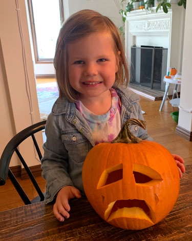 child with pumpkin